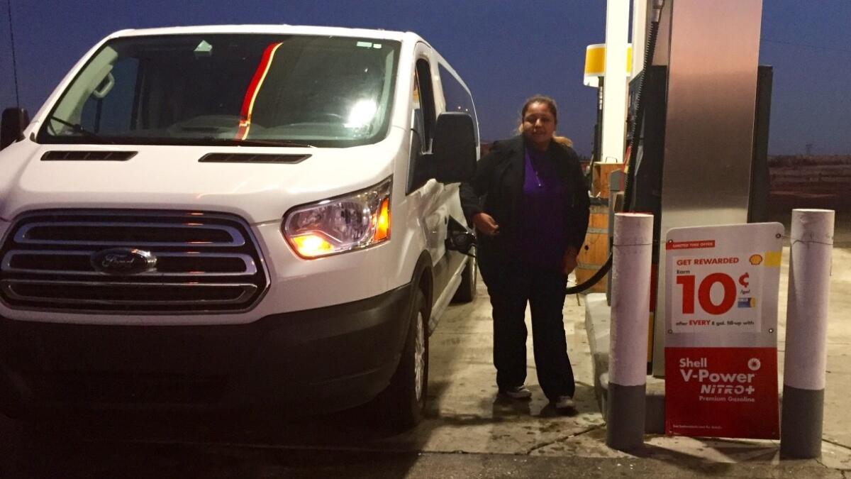 SEIU organizer Jasmin Castillo puts gas in a van full of sleeping janitors near the Nevada state line. The van left Los Angeles after 3 a.m. Saturday, right after their shifts ended.