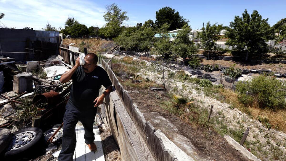 Tomas Garcia has not had running water at his home in East Porterville for two years and gets by with a water tank in his yard. A controversial proposal by California lawmakers could provide relief.