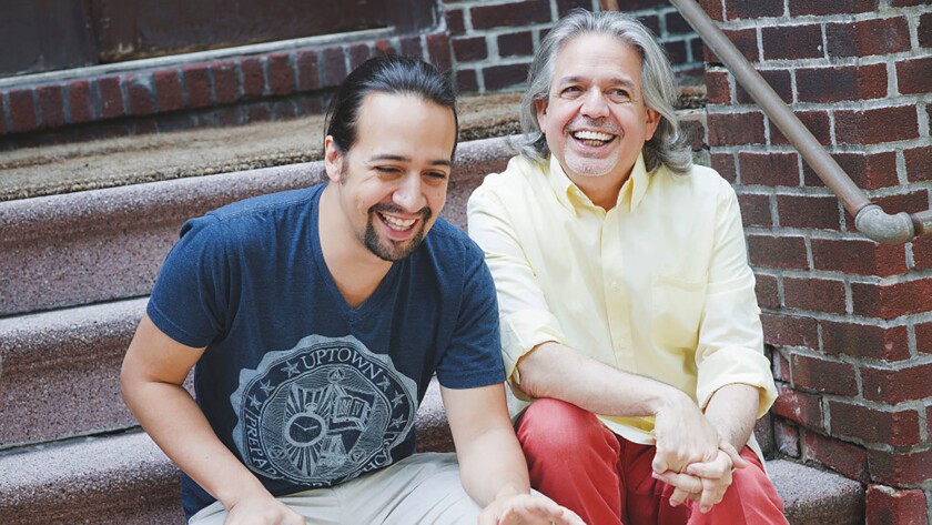 In this undated photo provided by Monica Simoes, Lin-Manuel Miranda, left, laughs with his father Luis Miranda Jr. The award-winning “Hamilton” creator says the inspirations for his art and philanthropy are linked. With a series of donations to organizations helping immigrants announced Tuesday, July 6, 2021, Miranda and his family’s nonprofit will support the new focus on immigration in the movie version of his musical “In the Heights.” (Monica Simoes via AP)