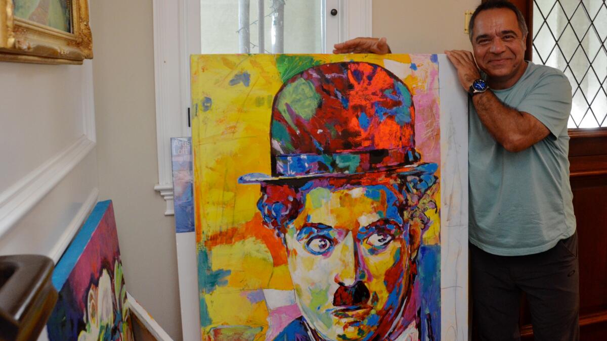 Artist Reza Safa of Corona del Mar shows his oil and acrylic painting of Charlie Chaplin that will be featured at Art in the Park on Saturday at the Newport Beach Civic Center.