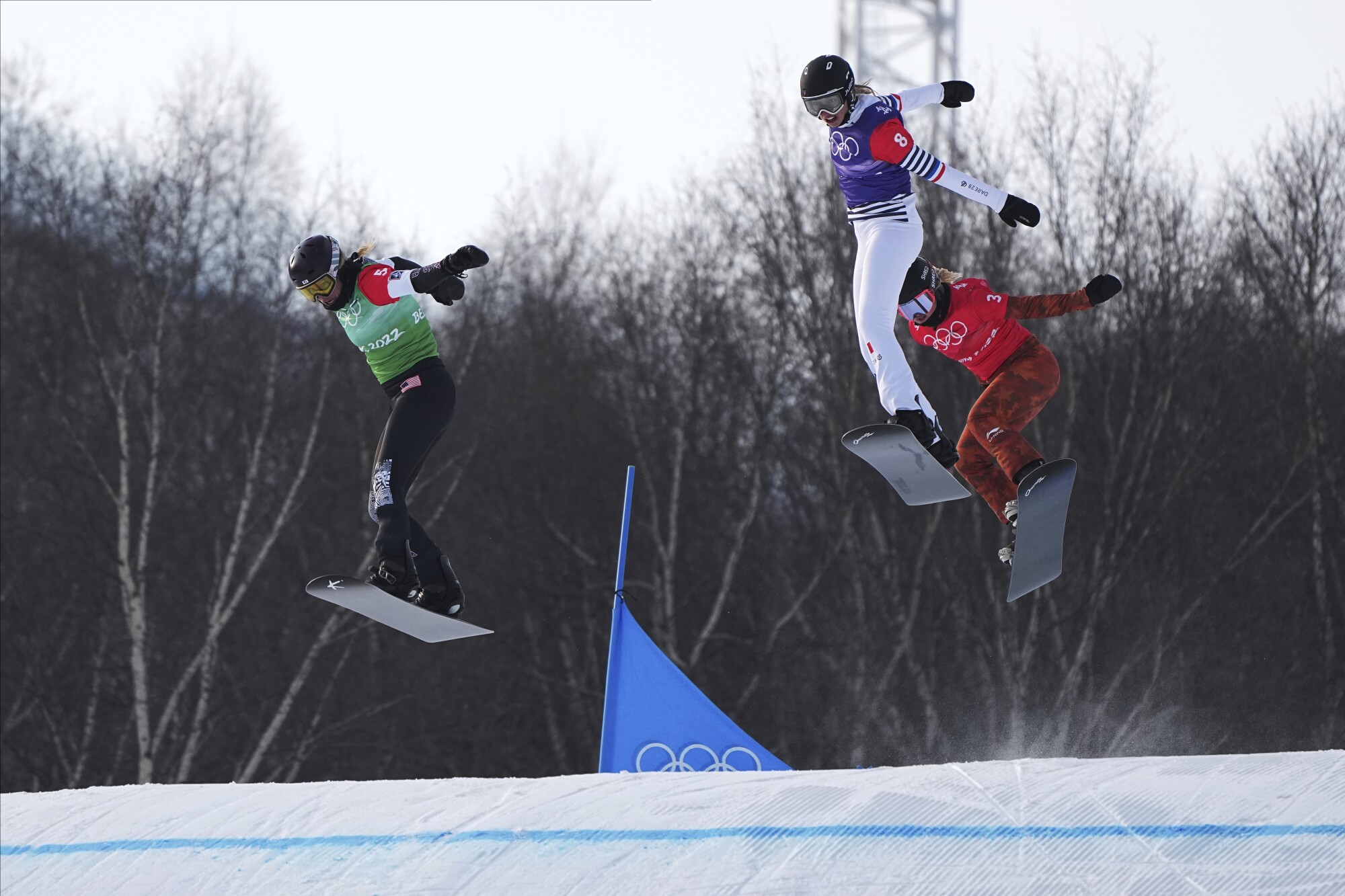 Lindsey Jacobellis, Chloe Trespeuch and Meryeta O'Dine snowboard at the 2022 Olympics.