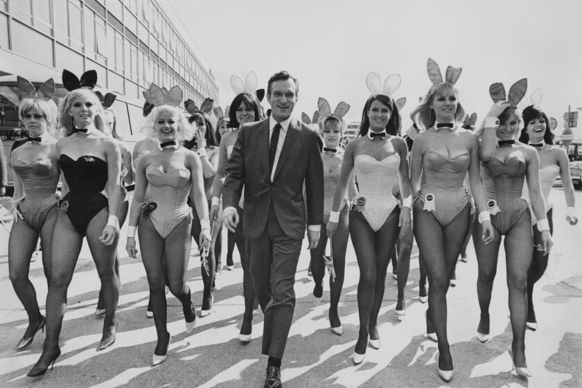 American publisher Hugh Hefner arrives at London Airport from Chicago with an entourage of Playboy Bunnies, 26th June 1966. He is in the capital for the opening of the London Playboy Club on Park Lane. (Photo by Ted West/Central Press/Hulton Archive/Getty Images)