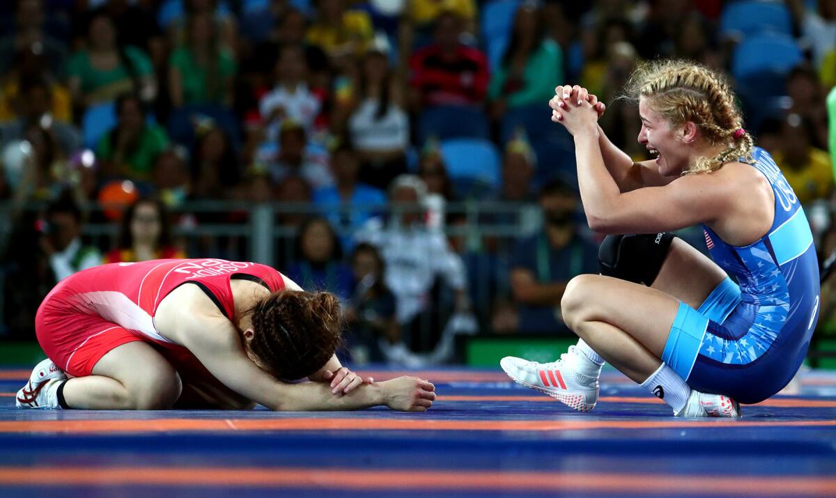 Helen Maroulis of the U.S., right, celebrates after beating Japan's Saori Yoshida to win a gold medal in freestyle wrestling.