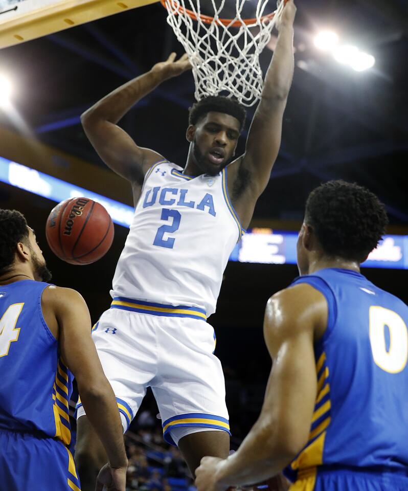 UCLA forward Cody Riley finishes a dunk.