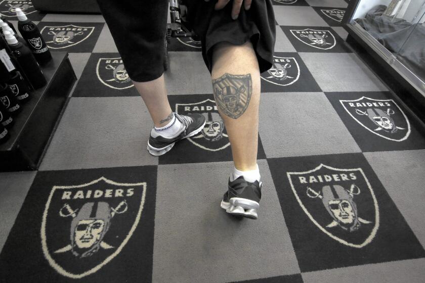 Al Romero of Salt Lake City shows off his Raiders tattoo during a visit to the Raider Image store.