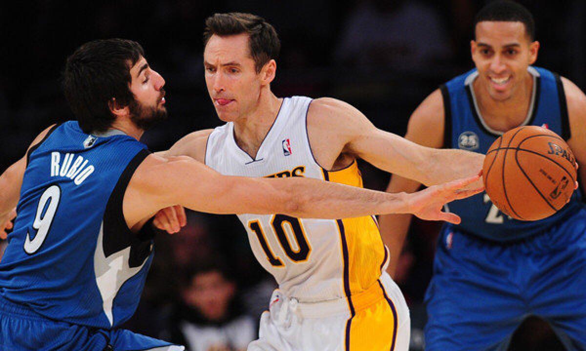Lakers guard Steve Nash, right, tries to dribble past Minnesota Timberwolves guard Ricky Rubio during the first half of Sunday's game at Staples Center.