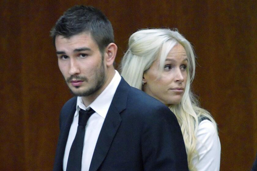 FILE - In this July 2, 2015, file photo, Los Angeles Kings' Slava Voynov enters Superior Court with his wife, Marta Varlamova, in Torrance, Calif. A judge has dismissed a misdemeanor domestic abuse conviction against the former Los Angeles Kings defenseman, a move that could clear a path for his return to the NHL. The judge granted Voynov's request to dismiss his conviction on Monday, July 2, 2018, â over the objection of Los Angeles County prosecutors â three years after he pleaded no contest to a misdemeanor charge of corporal injury to a spouse. Police said he punched, kicked and choked his wife at their Redondo Beach home in October 2014. (Brad Graverson/Los Angeles Daily News/SCNG via AP, File)