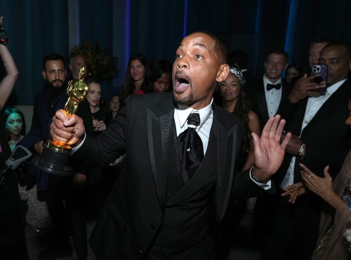 Will Smith holding his Oscar