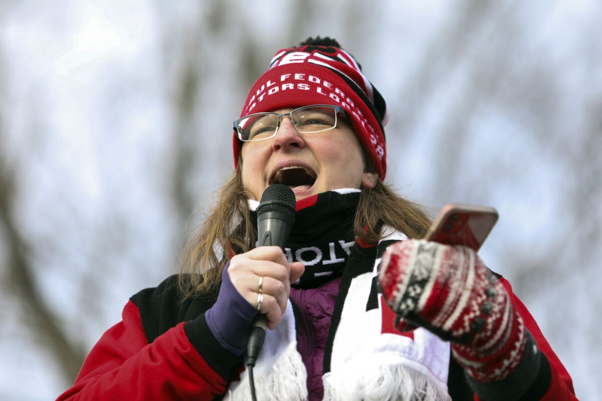 Leah VanDosser, of the St. Paul Federation of Educators, speaks to Twin Cities teachers and their supporters, Saturday, Feb. 12, 2022 in Minneapolis. Teachers in Minneapolis and St. Paul public schools could go on strike as early as Tuesday, March 8, 2022, over demands for higher wages, smaller class sizes and more mental health services. (Hannah Hobus/Pioneer Press via AP)
