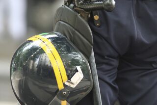 Helmet and truncheon (police baton) on a police officer