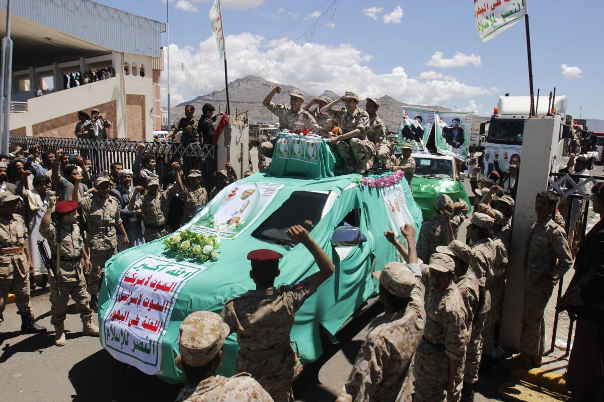 Houthi fighters chant slogans during the funeral procession for people killed last week in suicide bombings in Sana, Yemen.