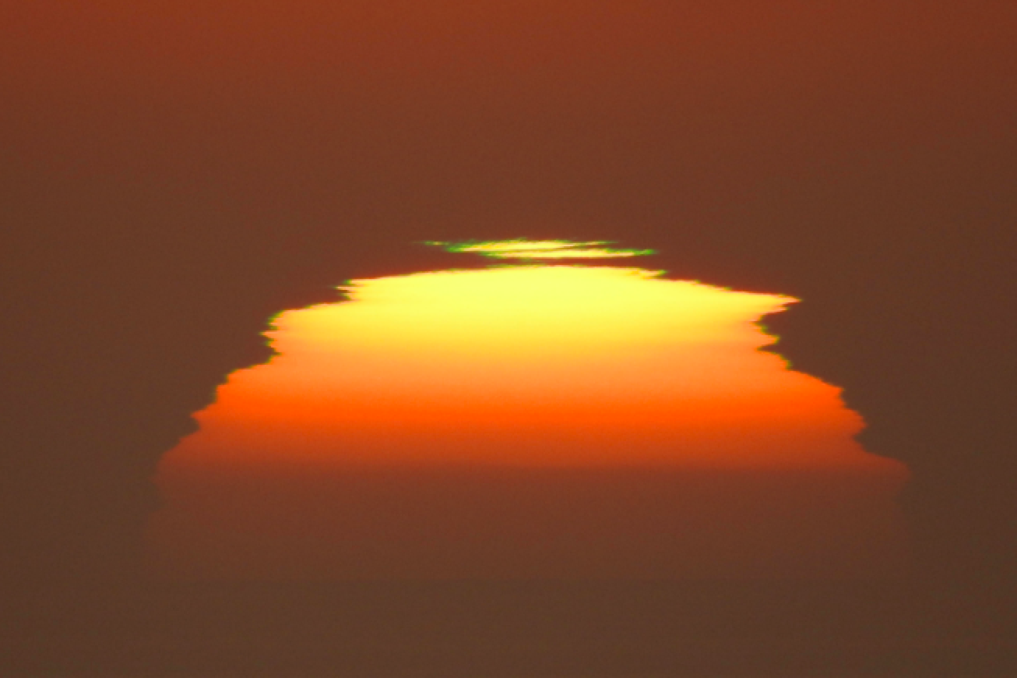 The view of the sun is distorted by heat.