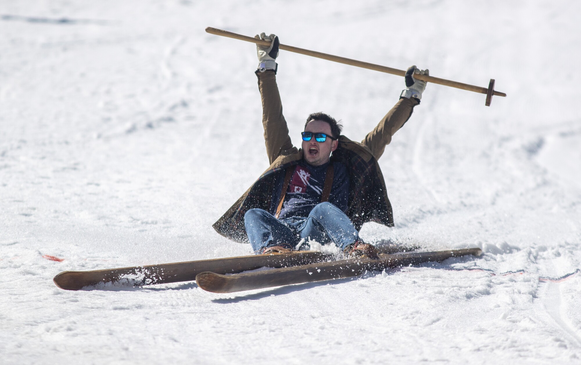 A ski racer raises his arms in triumph