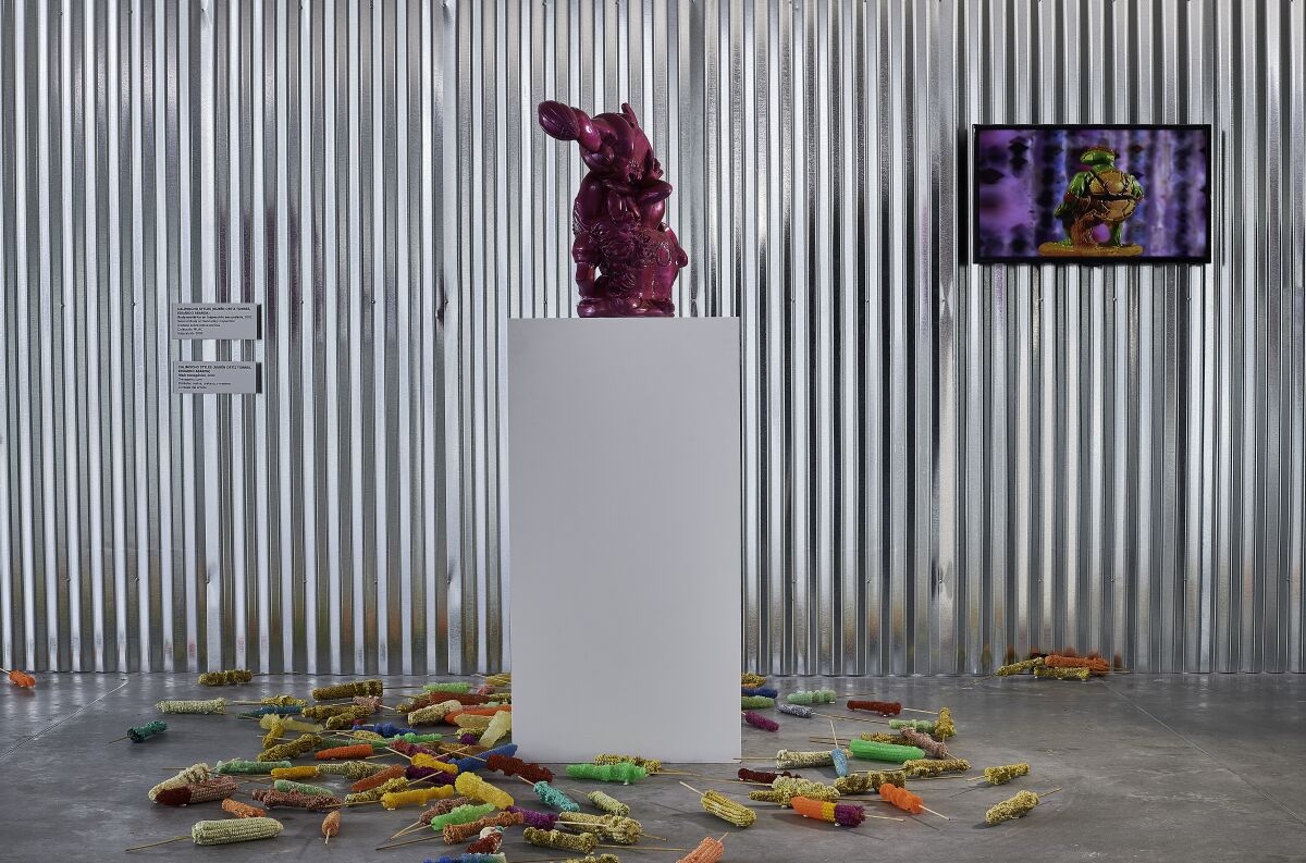 "Second Buda on Secondary Inspection," 2002 (on plinth), by Rubén Ortiz Torres, and "Transgenic Corn," 2002 (on the floor), by Ortiz and fellow artist Eduardo Abaroa.