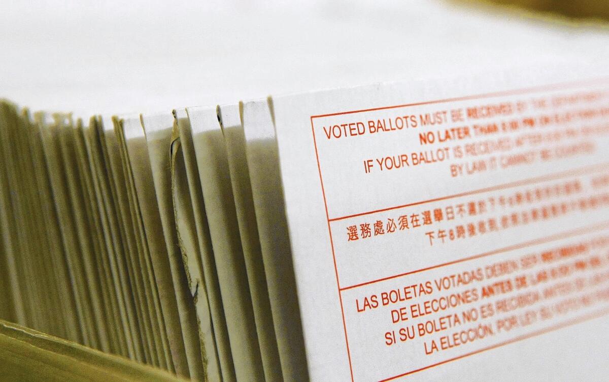 A stack of vote-by-mail ballots sit in a box at the San Francisco Department of Elections in 2008. Voting by mail has become more popular in recent years; some states have adopted mail-only elections.