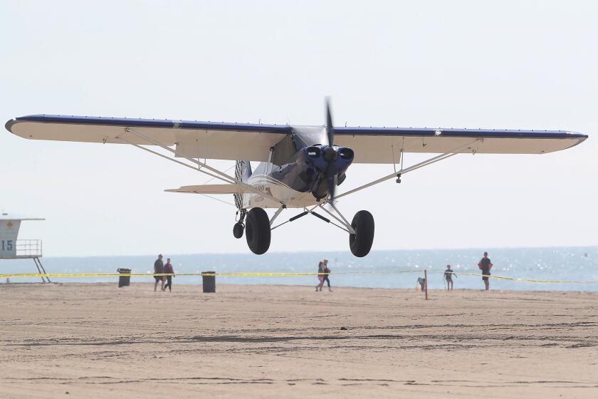 A Short Landing and Take-off aircraft better known as a STOL plane, makes a landing on the sand during the Pacific Airshow press conference on the beach at the end of Huntington St. in Huntington Beach on Thursday. The STOL is popular with Alaska bush pilots because of their ability to land on short runways or water with minimal effort. The planes will be featured in the 2024 Pacific Air Show. This year, the Pacific Airshow will build a temporary runway on the sand for touch and go landings to entertain the crowd.