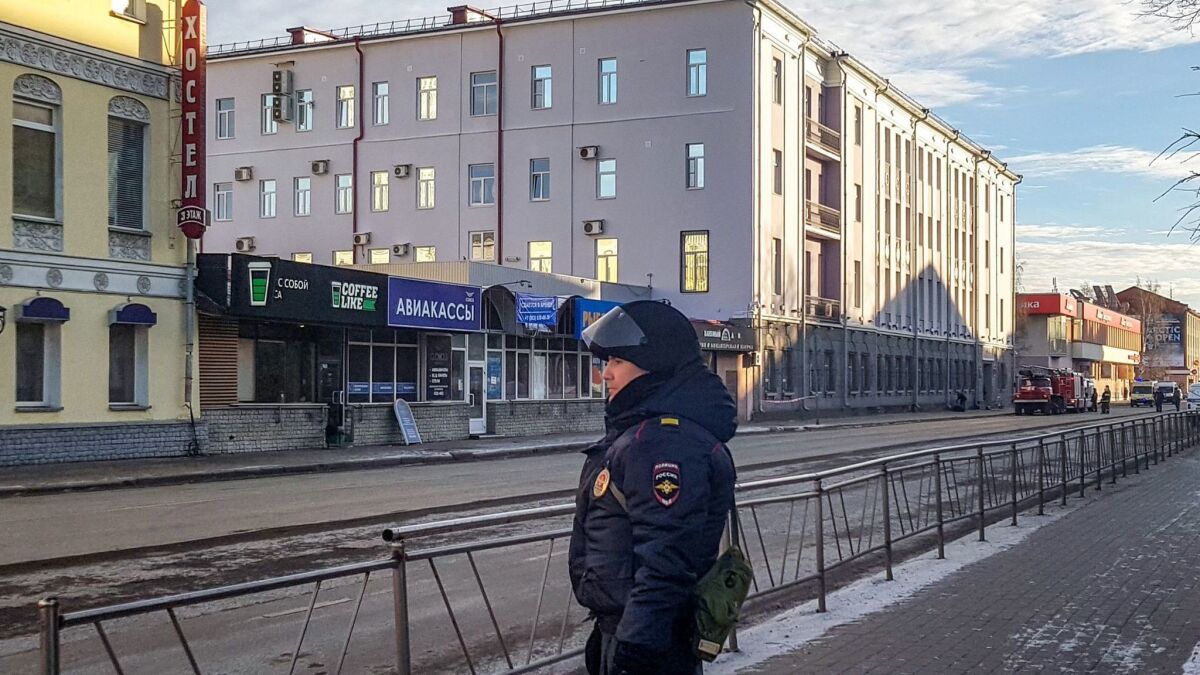 A police officer patrols the street near the FSB security service offices in Arkhangelsk, Russia, following a fatal explosion Wednesday.