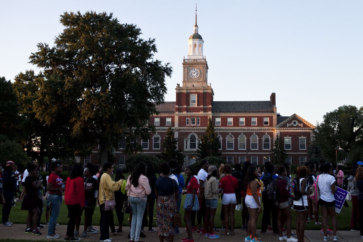 Students and alumni line up to receive T-shirts and posters on the Yard at Howard University.