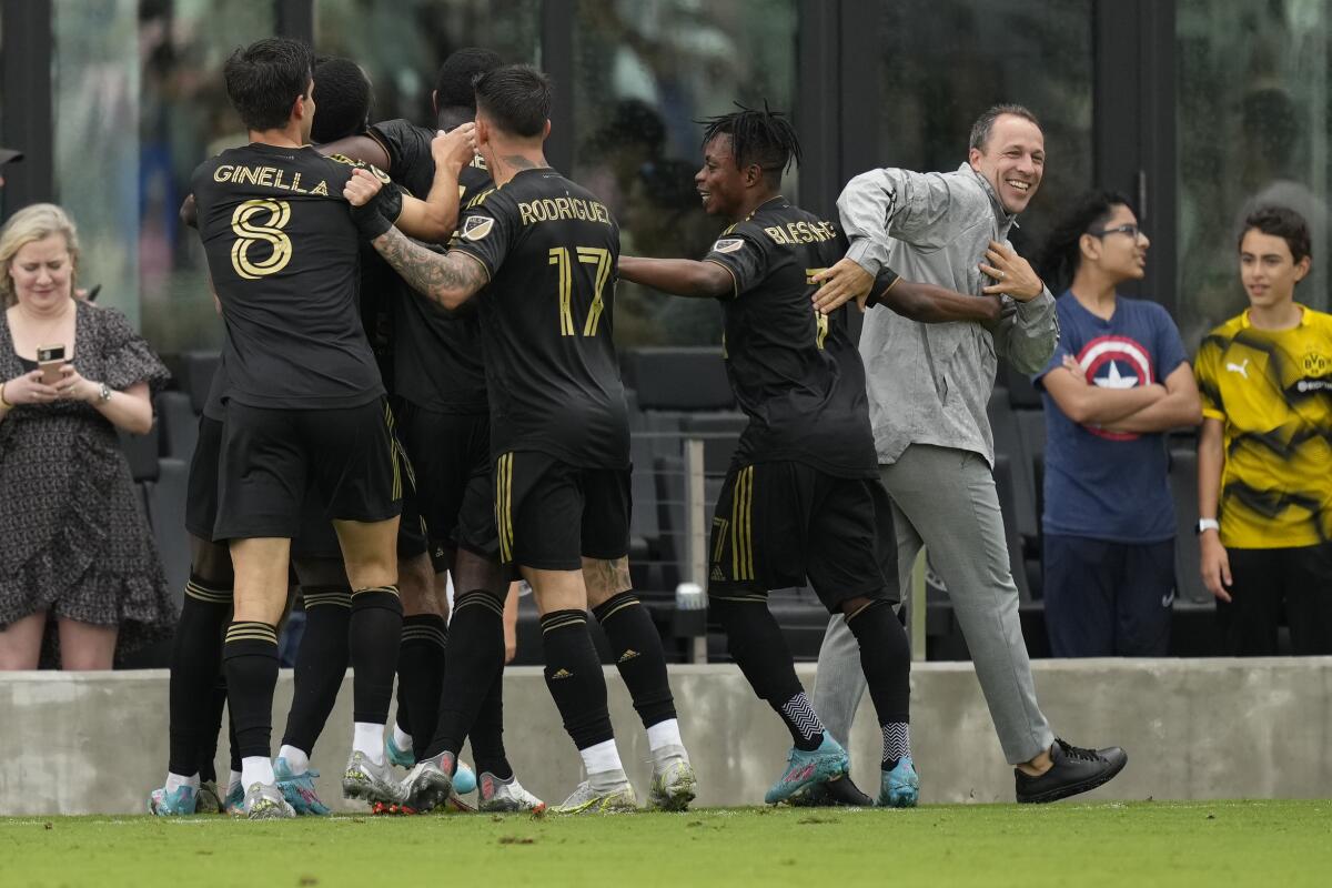 LAFC coach Steve Cherundolo, right, congratulates players as they celebrate on the pitch after against Inter Miami in 2022
