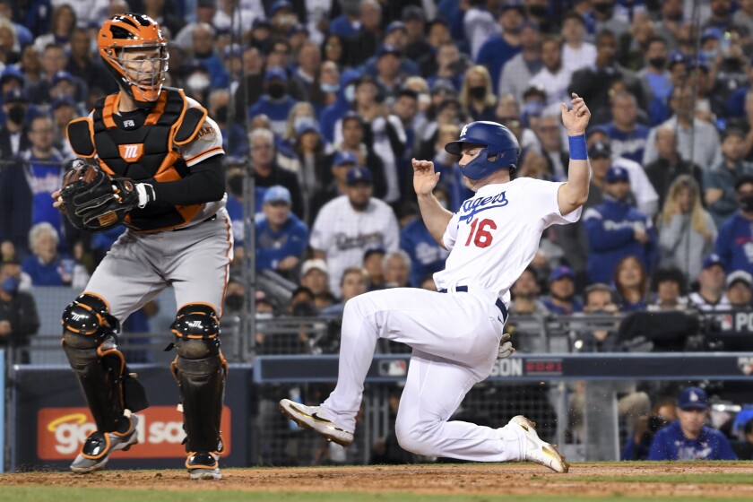 Dodgers catcher Will Smith is forced out at home by San Francisco Giants catcher Buster Posey.