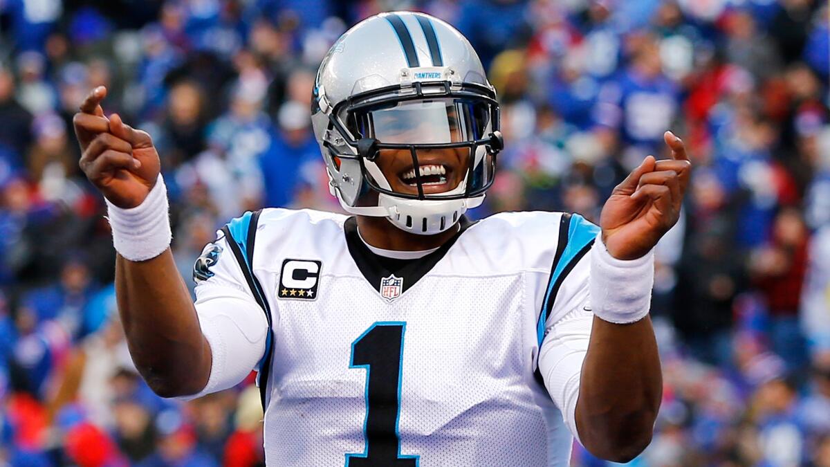 Quarterback Cam Newton celebrates after the Panthers scored a touchdown in the second half Sunday.
