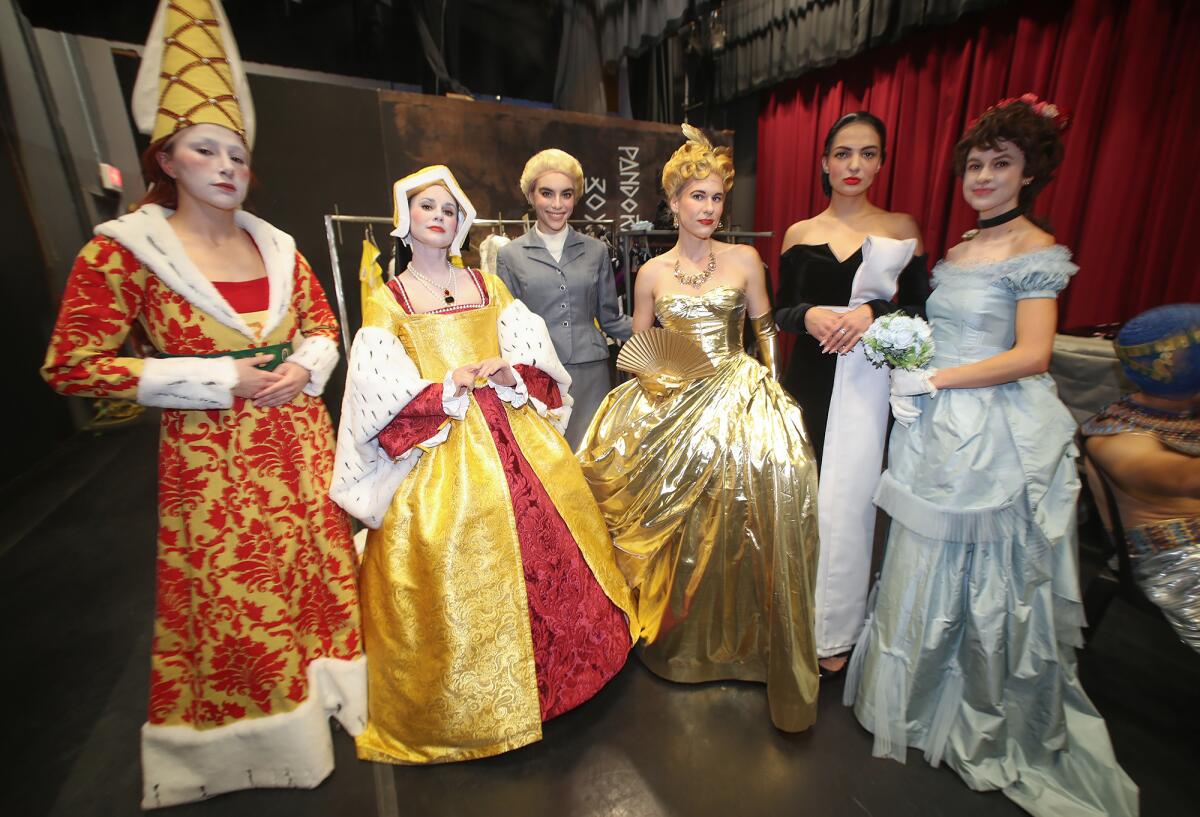 Cast members prepare for the opening act for the "À La Mode: The Art of Fashion."
