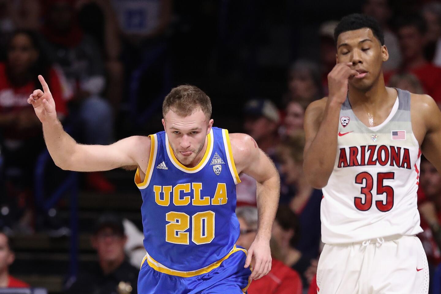 Bruins guard Bryce Alford (20) celebrates after making a three-point basket against Allonzo Trier (35) and Arizona during the first half.