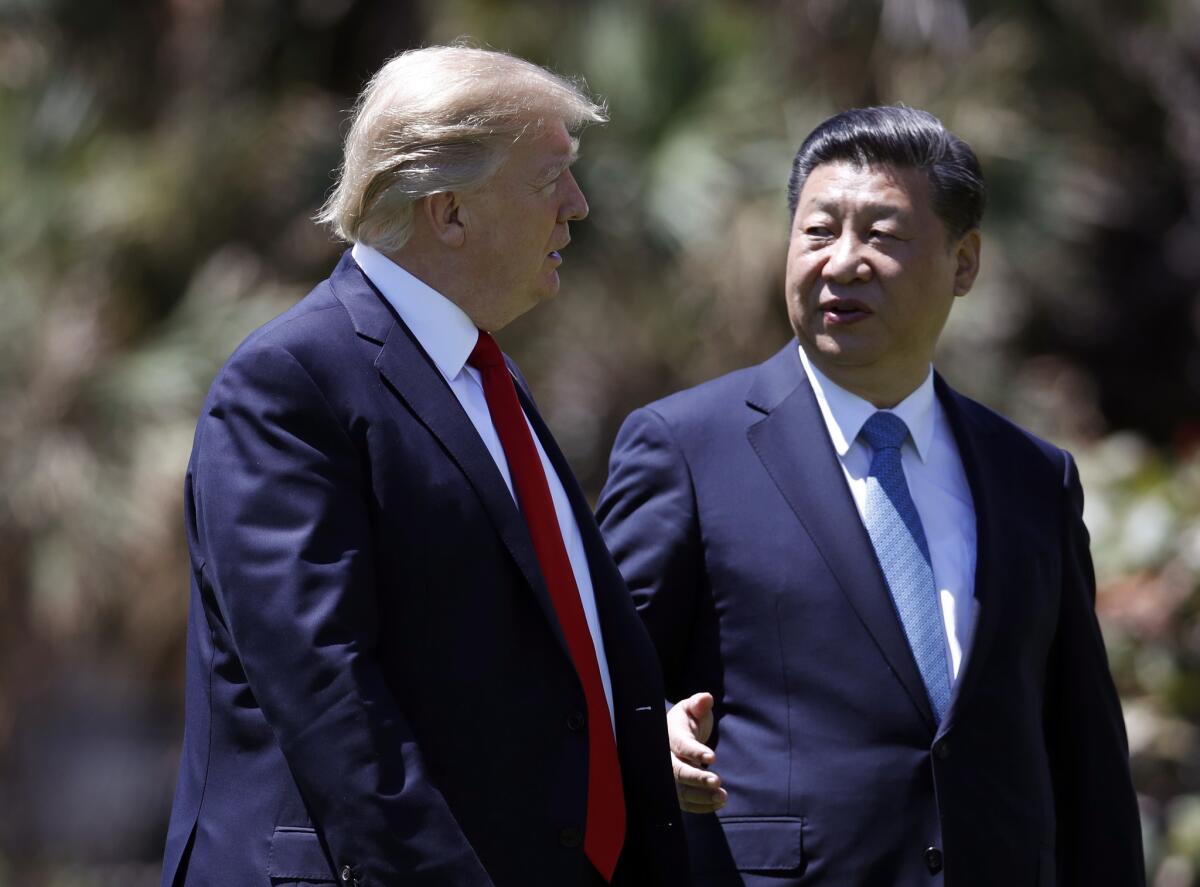 President Trump and Chinese President Xi Jinping walk April 7 after their meetings at Mar-a-Lago.