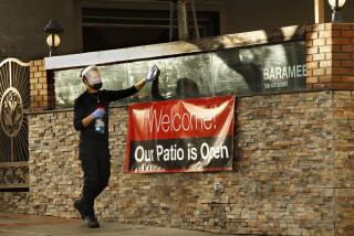 San Pedro, California-Jan. 29, 2021- At Baramee Thai Restaurant in San Pedro, California, an employee washes the windows as they reopen for outdoor dining on Jan. 29, 2021. (Carolyn Cole / Los Angeles Times)