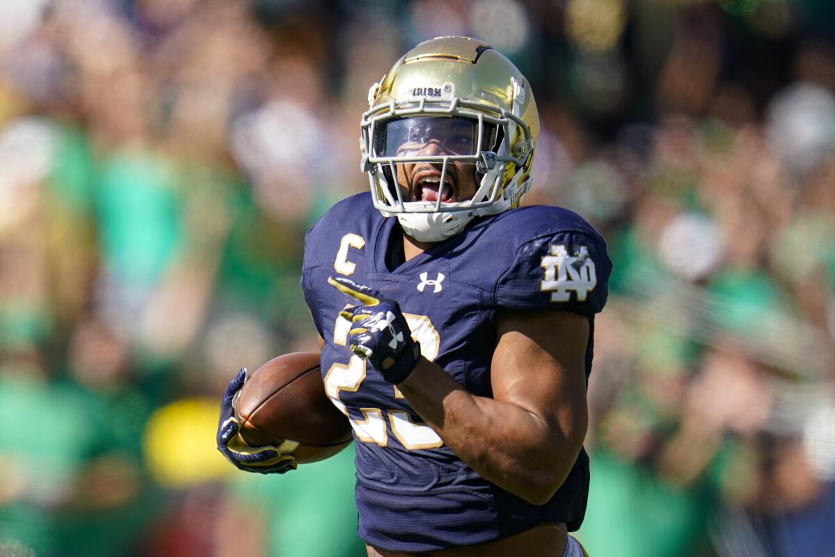 A football player runs with the ball