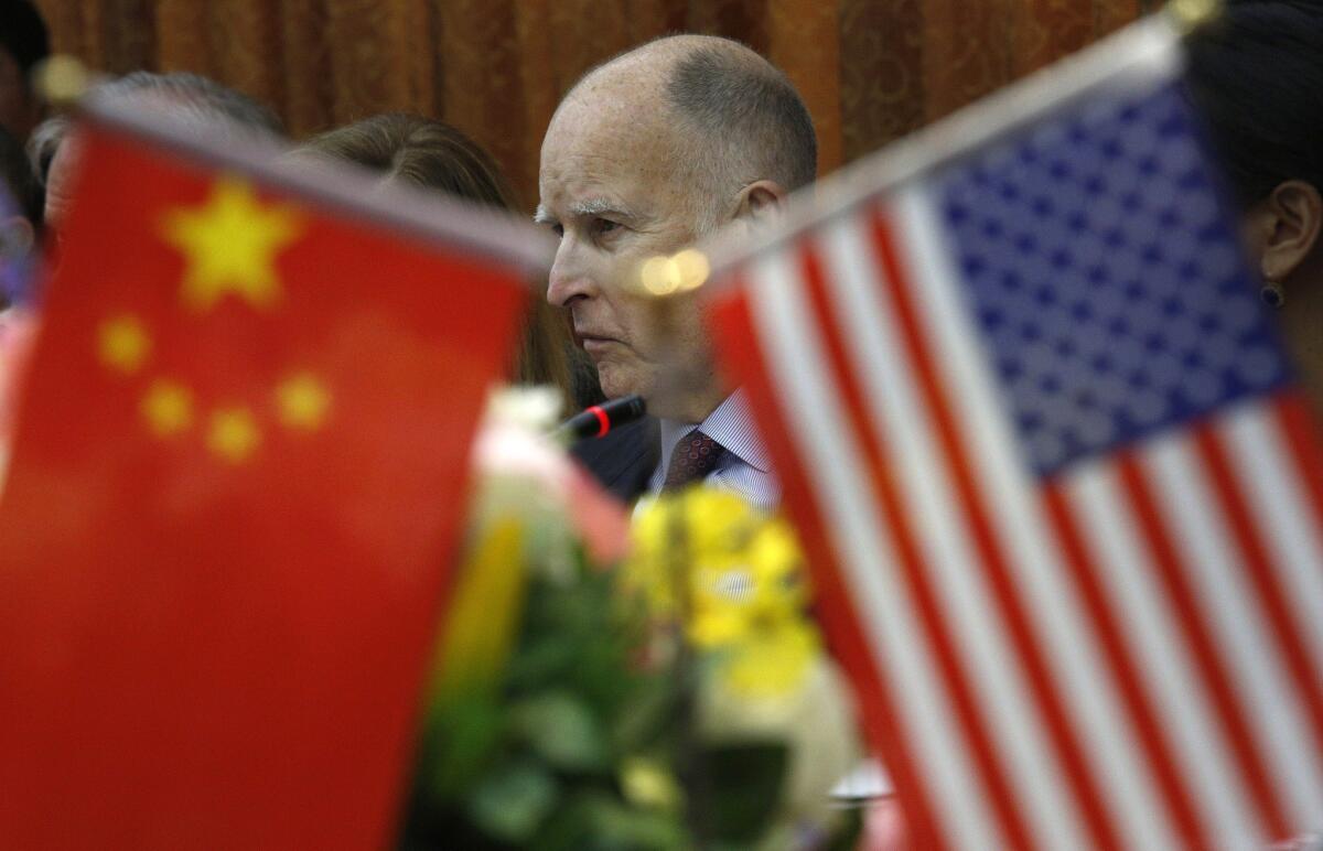 Gov. Jerry Brown participates in a meeting at the automaker BYD Co. in China