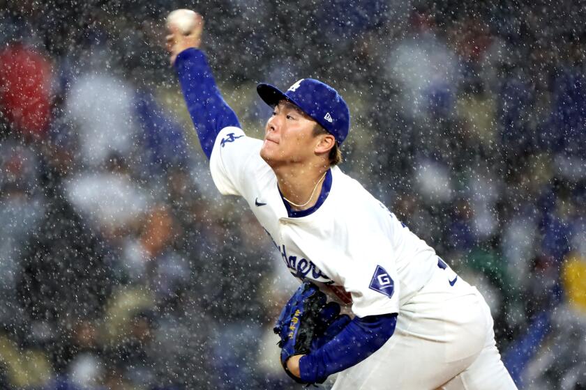 LOS ANGELES, CALIFORNIA - MARCH 30: Dodgers pitcher Yoshinobu Yamamoto throws a pitch.