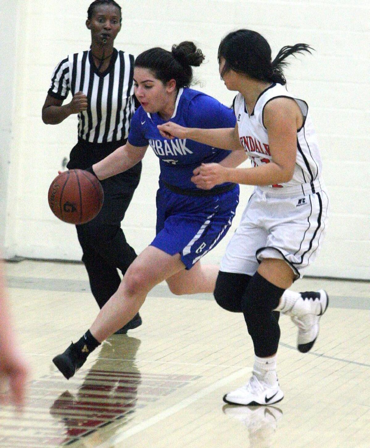 Burbank's Osanna Tirityan brings the ball up court against Glendale's Claire Yanai in a Pacific League girls' basketball game at Glendale on Monday.