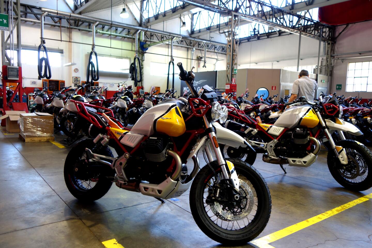 A pair of Moto Guzzi V85 TT motorcycles are seen in the foreground at the factory in Mandello Del Lario, Italy.