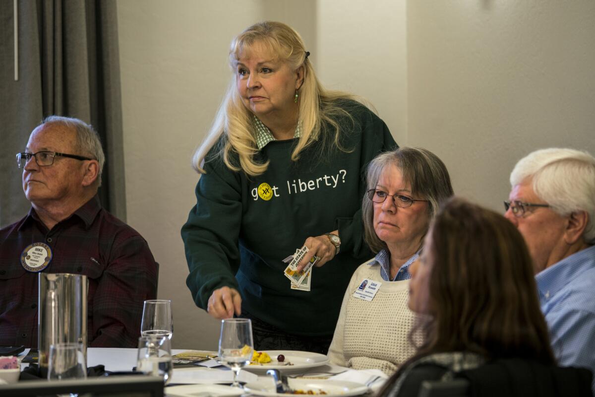 Sally Rapoza hands out pamphlets a Rotary Club meeting in February.