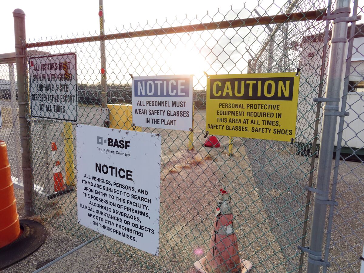A gate at the entrance to the former Ciba Geigy chemical plant in Toms River, N.J., is filled with warning on Tuesday, Jan. 24, 2023, regarding the contaminated area, which is on the Superfund list of the nation's worst toxic waste sites. A proposed settlement to restore natural resources damaged by the company's dumping is widely opposed as insufficient by residents of Toms River, where childhood cancer rates from the late 1970s through 1990s occurred at elevated rates. (AP Photo/Wayne Parry)