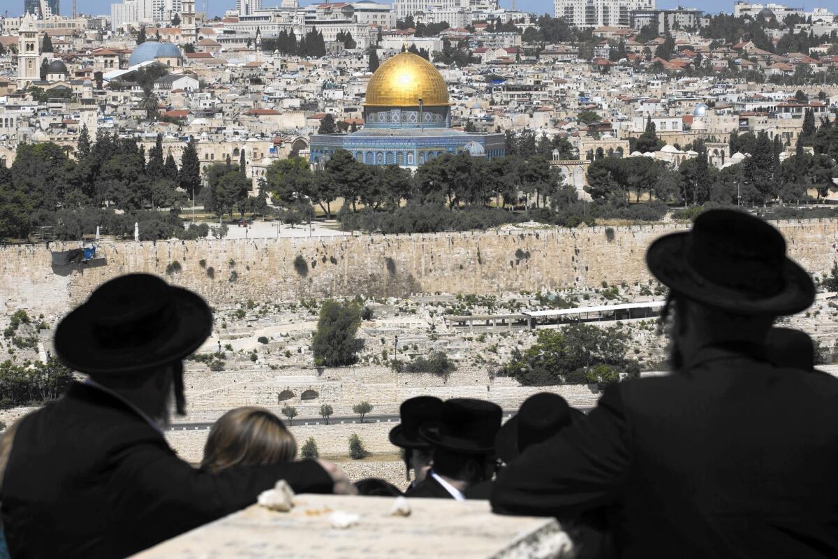 Ultra-Orthodox Jews walk through the ancient Jewish cemetery on the Mount of Olives in Jerusalem's old city on April 17.