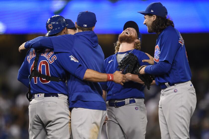 The Chicago Cubs celebrate a combined no-hitter after the final out by relief pitcher Craig Kimbrel, second from right, after a baseball game against the Los Angeles Dodgers in Los Angeles, Thursday, June 24, 2021. The Cubs won 4-0. (AP Photo/Kelvin Kuo)