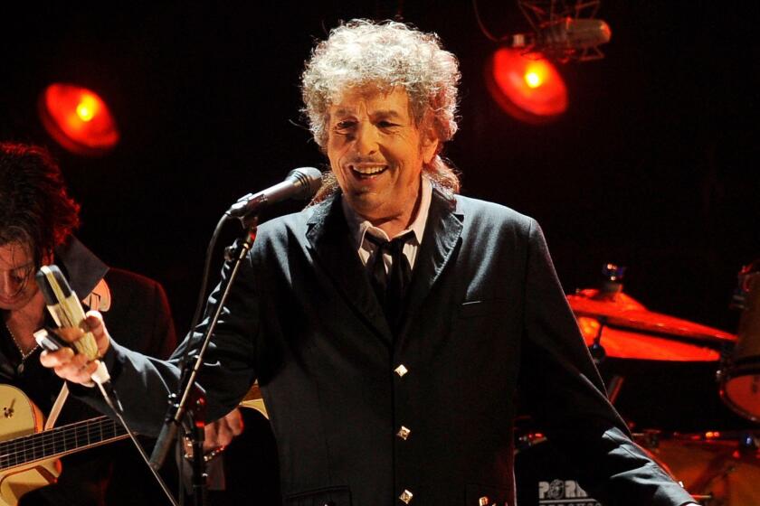 FILE - In this Jan. 12, 2012, file photo, Bob Dylan performs in Los Angeles. The Swedish Academy says 2016 Nobel literature winner Bob Dylan will meet with members of the academy this weekend and they will hand over his Nobel diploma and medal. (AP Photo/Chris Pizzello, File)