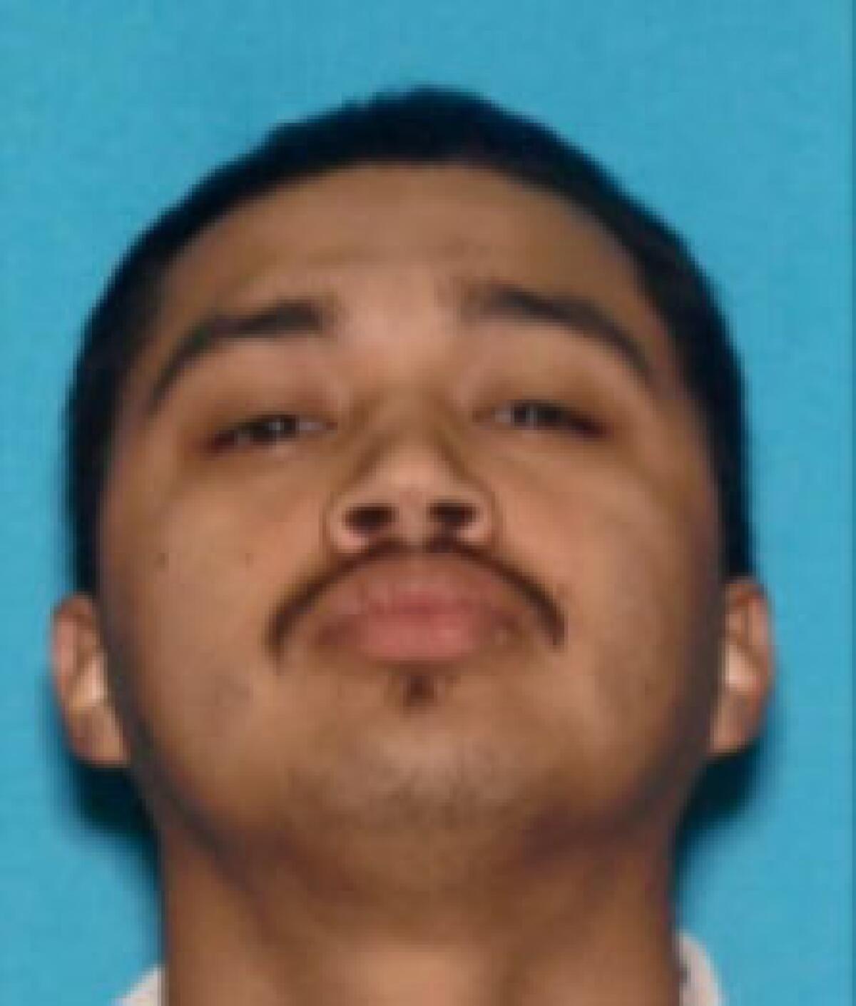 Mugshot of a man with dark hair and mustache.