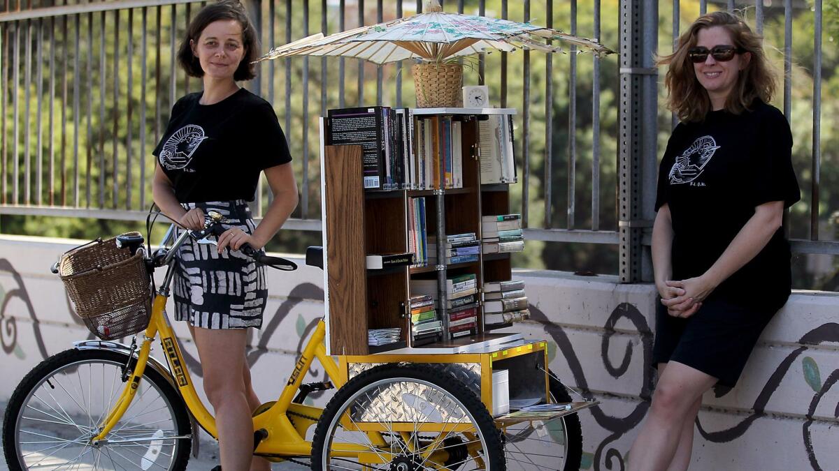 The Feminist Library on Wheels (F.L.O.W.) in 2014 with creators Jenn Witte, left, and Dawn Finley.