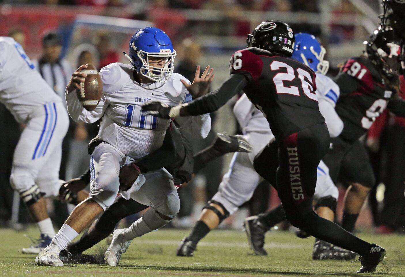 Norco quarterback Victor Viramontes (10) is sacked by Corona Centennial's Octavio Cortes (7) and Josh Wilson (23) during a game on Thursday night.