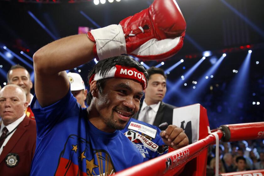 Manny Pacquiao acknowledges the fans as he prepares to enter the ring for his title fight against Timothy Bradley.