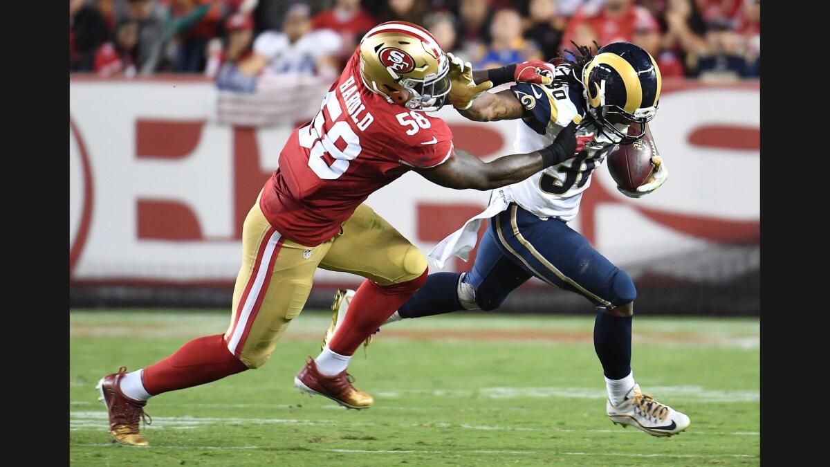 Rams running back Todd Gurley is held to a 1-yard gain as 49ers linebacker Eli Harold brings him down in the 3rd quarter.