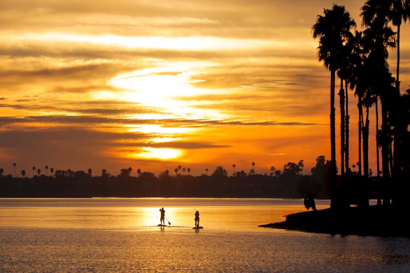 SAN DIEGO, CA 11/14/2017: Against a backdrop of the setting sun, two paddleboarders make their way around Mission Bay at De Anza Cove. Staff photo by Howard Lipin/The San Diego Union-Tribune/ZUMA Press Copyright 2017 The San Diego Union-Tribune