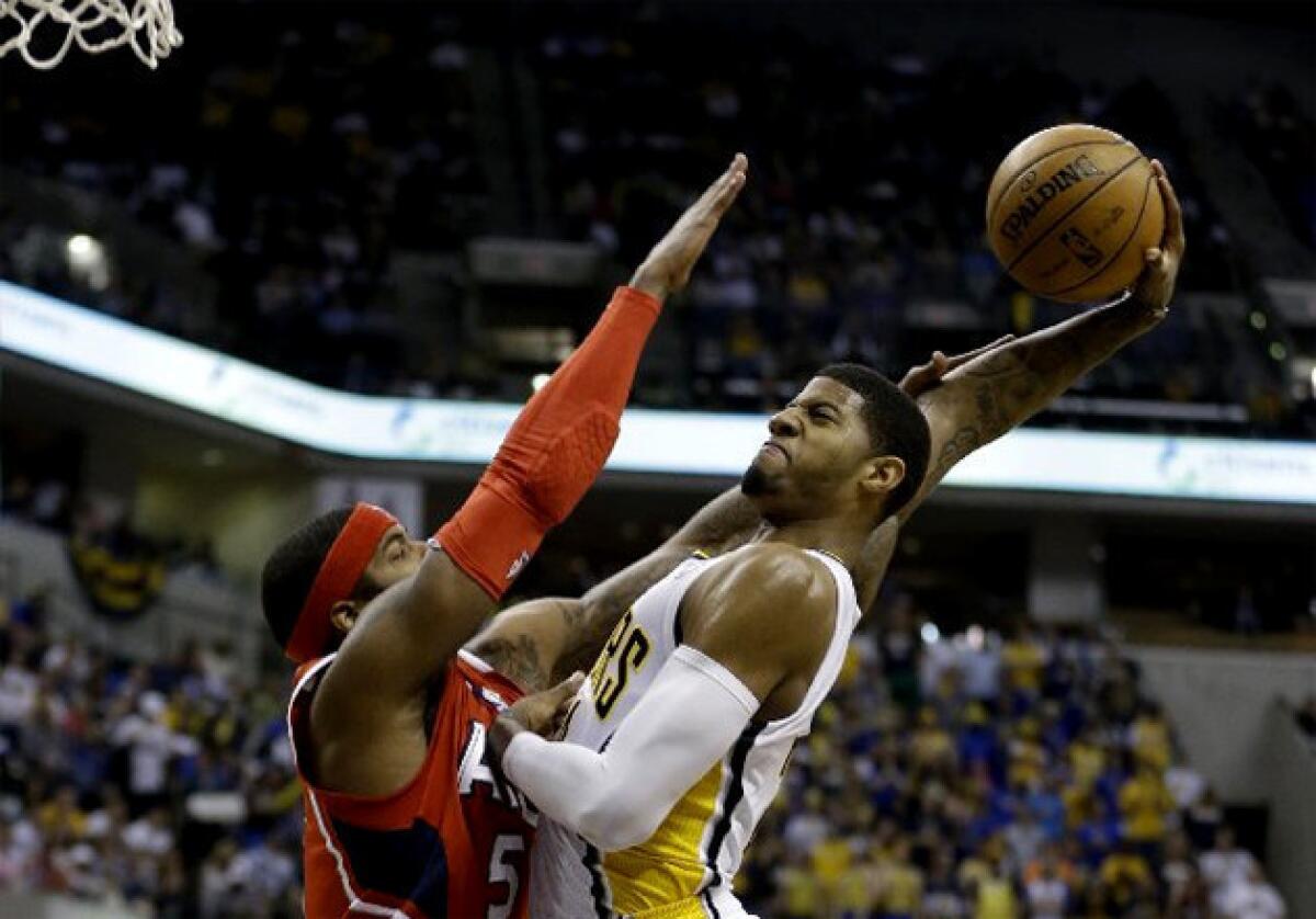 Indiana Pacers' Paul George goes up for a dunk over Atlanta Hawks forward Josh Smith.
