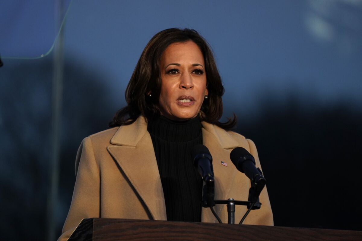 Vice President-elect Kamala Harris speaks at a lectern during a COVID-19 memorial Tuesday in Washington.