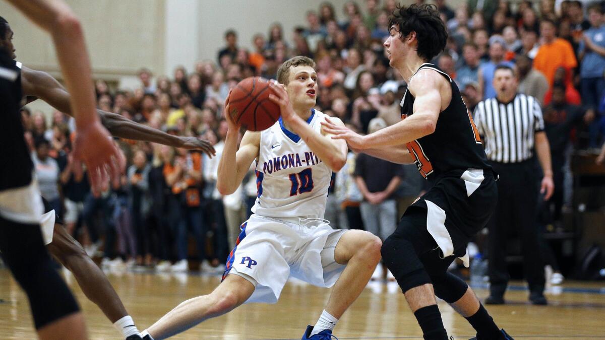 Junior guard Micah Elan is defended by Occidental's Caleb Yellin-Flaherty.