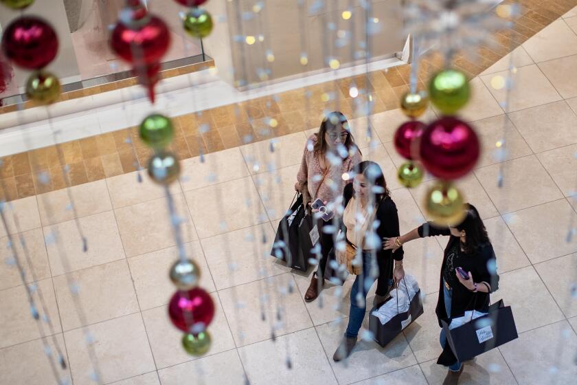 COSTA MESA, CA - NOVEMBER 25, 2022: Black Friday shoppers are treated to festive decorations throughout South Coast Plaza on November 25, 2022 in Costa Mesa, California.(Gina Ferazzi / Los Angeles Times)