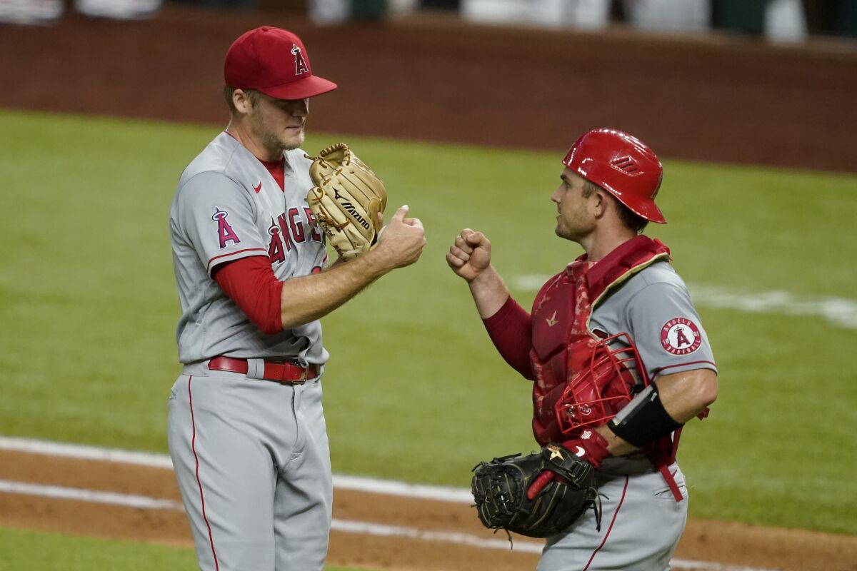 Angels relief pitcher Ty Buttrey and catcher Max Stassi celebrate their win over the Texas Rangers.